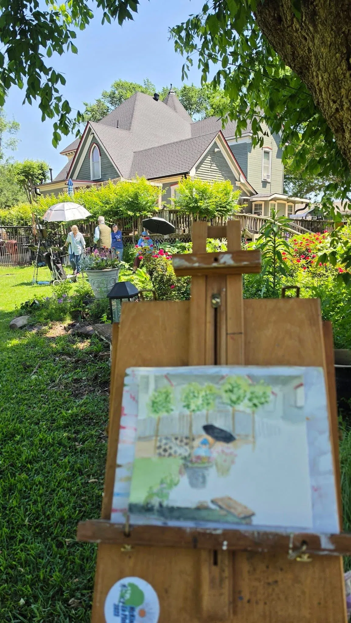 Artist easel set up on the Four Winds grounds with the Victorian house in the background