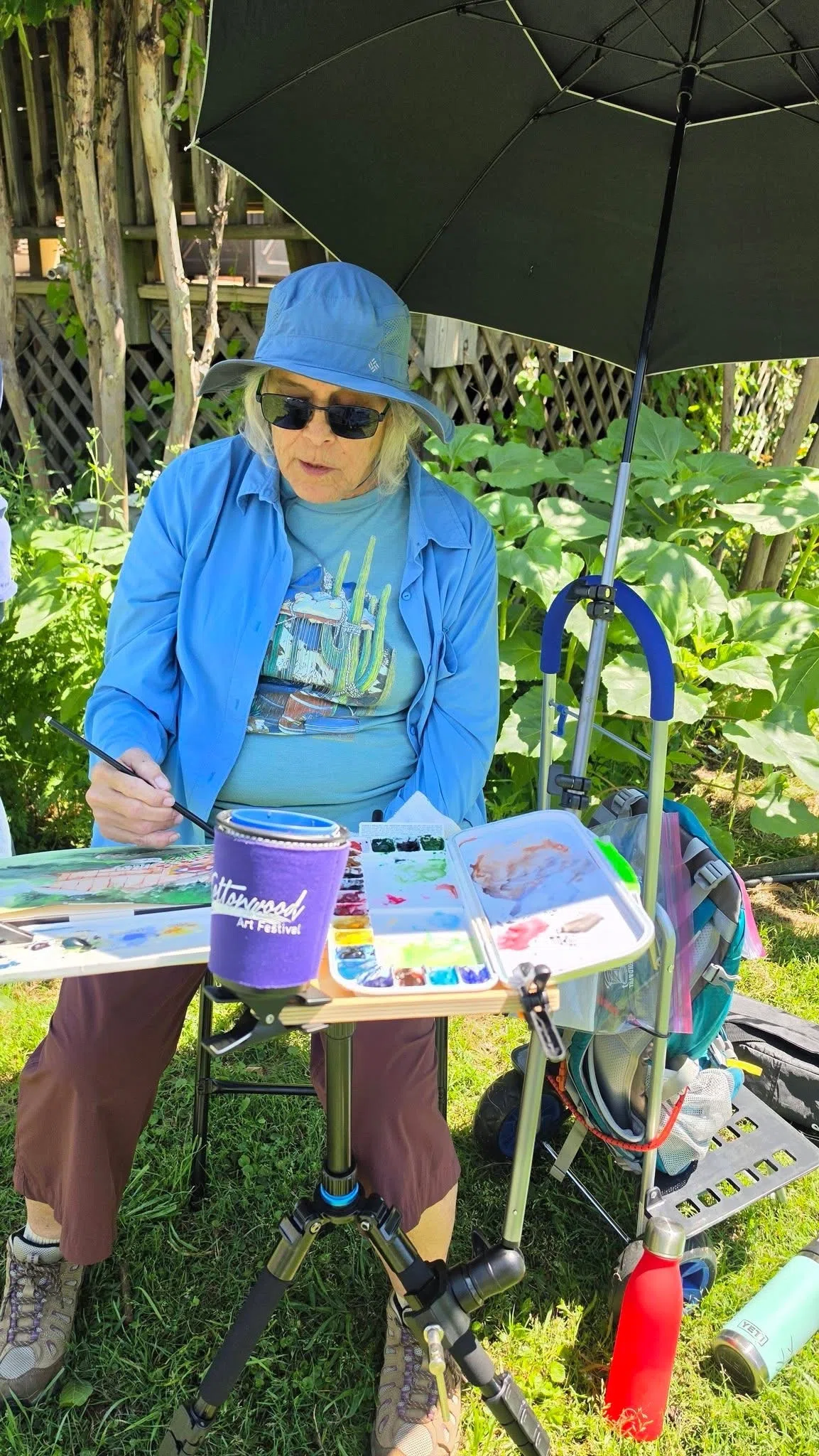 Watercolor painter working with supplies outdoors at Four Winds in Bonham Texas
